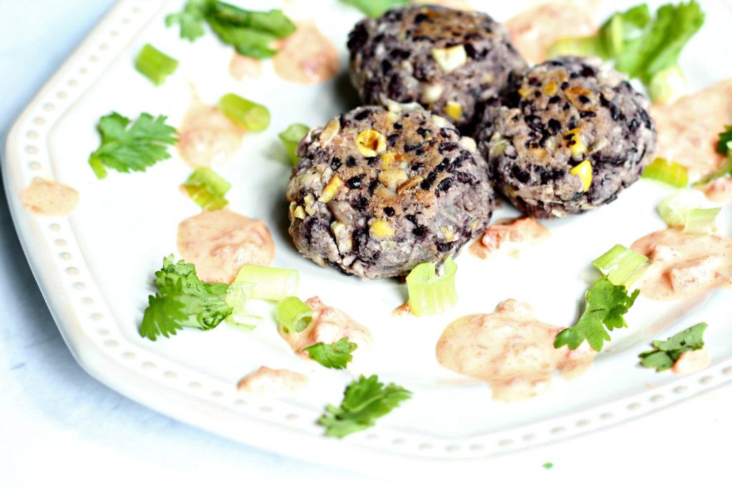 black rice corn cakes with red pepper sauce